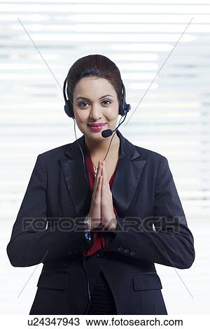 Portrait of beautiful call center representative greeting in office View Large Photo Image Stock Image - Portrait of beautiful call center representative greeting in office. Fotosearch