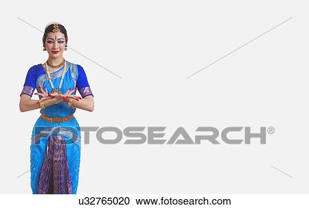 Stock Image - Portrait of beautiful dancer performing Bharatanatyam against white background. Fotosearch