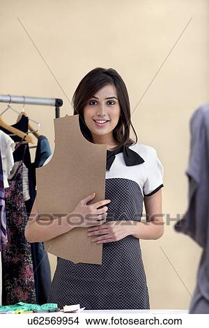 Portrait of beautiful young fashion designer in clothing store View Large Photo Image Picture - Portrait of beautiful young fashion designer in clothing store . Fotosearch