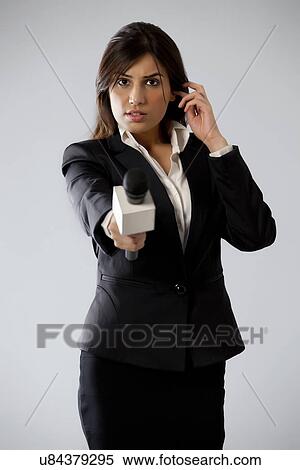 Portrait of beautiful young woman reporter listening through earphone View Large Photo Image Stock Photography - Portrait of beautiful young woman reporter listening through earphone . Fotosearch