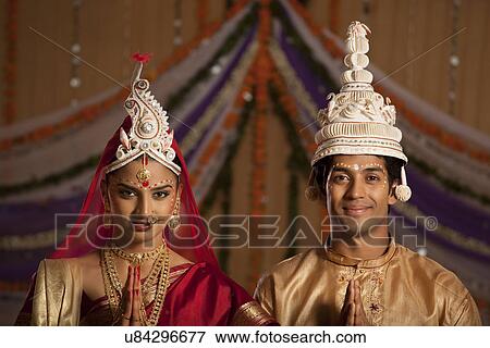 Stock Photo - Portrait of Bengali bride and groom greeting . Fotosearch