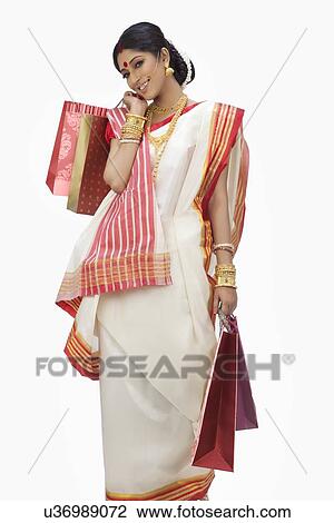 Portrait of Bengali woman carrying shopping bags View Large Photo Image Stock Image - Portrait of Bengali woman carrying shopping bags. Fotosearch