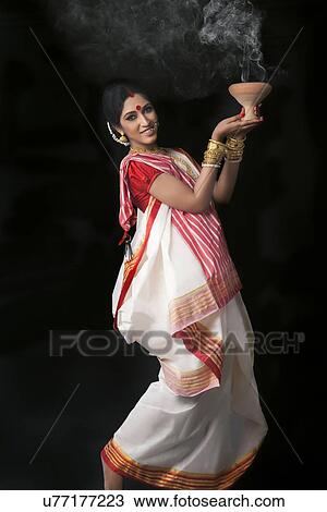 Portrait of Bengali woman doing dhunuchi dance View Large Photo Image Stock Image - Portrait of Bengali woman doing dhunuchi dance. Fotosearch