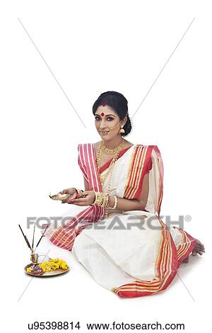 Picture - Portrait of Bengali woman holding a diya. Fotosearch