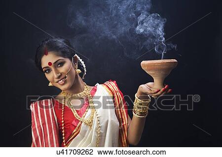 Portrait of Bengali woman holding a dhunuchi View Large Photo Image Stock Image - Portrait of Bengali woman holding a dhunuchi. Fotosearch