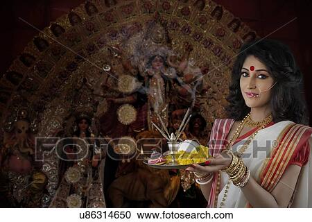 Portrait of Bengali woman holding a puja thali View Large Photo Image Stock Image - Portrait of Bengali woman holding a puja thali. Fotosearch