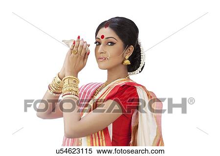 Portrait of Bengali woman holding a conch shell View Large Photo Image Stock Photography - Portrait of Bengali woman holding a conch shell . Fotosearch