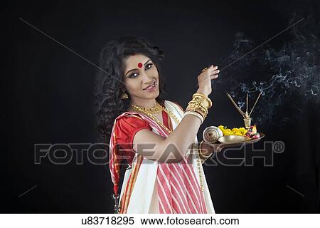 Stock Photography - Portrait of Bengali woman holding a puja thali. Fotosearch