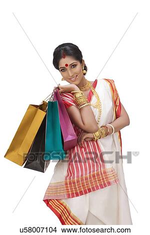 Picture - Portrait of Bengali woman holding shopping bags. Fotosearch
