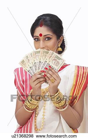 Portrait of Bengali woman holding currency notes View Large Photo Image Stock Photo - Portrait of Bengali woman holding currency notes . Fotosearch