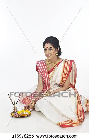 Stock Photography - Portrait of Bengali woman sitting with puja thali. Fotosearch