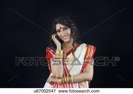 Stock Photo - Portrait of Bengali woman talking on a mobile phone. Fotosearch