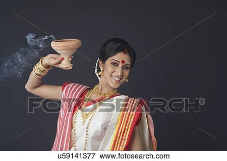 Portrait of Bengali woman with dhunuchi View Large Photo Image Stock Photo - Portrait of Bengali woman with dhunuchi . Fotosearch