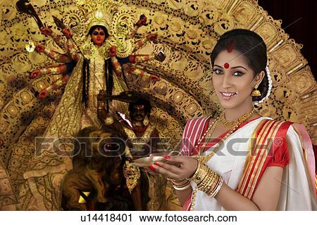 Stock Image - Portrait of Bengali woman with diya. Fotosearch