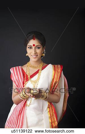 Portrait of Bengali woman with diya View Large Photo Image Stock Image - Portrait of Bengali woman with diya. Fotosearch