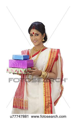 Stock Image - Portrait of Bengali woman with gifts. Fotosearch