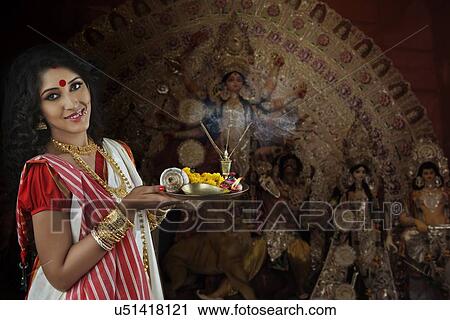 Stock Image - Portrait of Bengali woman with puja thali. Fotosearch