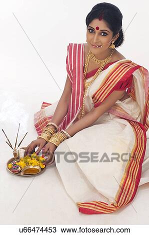 Stock Image - Portrait of Bengali woman with puja thali. Fotosearch