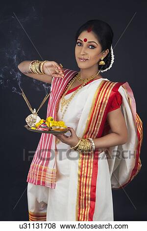 Portrait of Bengali woman with puja thali View Large Photo Image Stock Photo - Portrait of Bengali woman with puja thali. Fotosearch