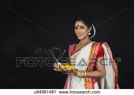 Stock Photo - Portrait of Bengali woman with puja thali. Fotosearch