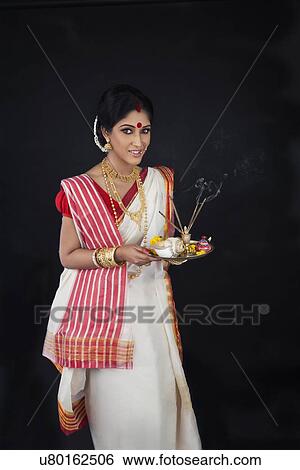Stock Photograph - Portrait of Bengali woman with puja thali. Fotosearch