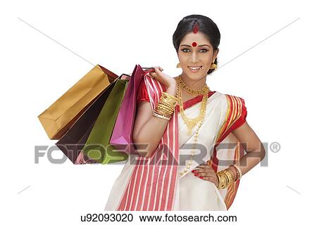 Stock Image - Portrait of Bengali woman with shopping bags. Fotosearch