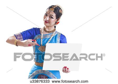 Portrait of Bharatanatyam dancer pointing at blank placard over white background View Large Photo Image Stock Image - Portrait of Bharatanatyam dancer pointing at blank placard over white background. Fotosearch