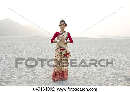 Stock Image - Portrait of Bihu dancer greeting . Fotosearch