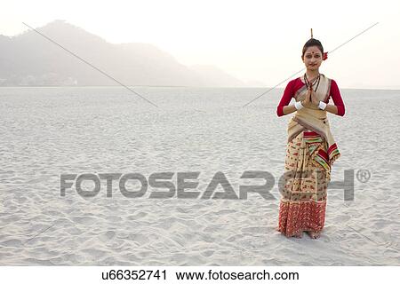 Stock Image - Portrait of Bihu dancer greeting . Fotosearch