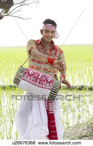 Portrait of Bihu man playing on a dhol View Large Photo Image Stock Photo - Portrait of Bihu man playing on a dhol . Fotosearch