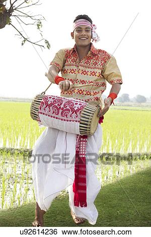 Portrait of Bihu man playing on a dhol View Large Photo Image Stock Photograph - Portrait of Bihu man playing on a dhol . Fotosearch