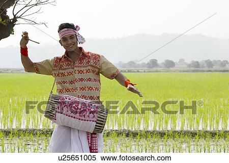 Portrait of Bihu man playing on a dhol View Large Photo Image Stock Photography - Portrait of Bihu man playing on a dhol . Fotosearch