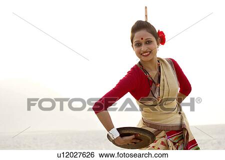 Portrait of Bihu woman dancing with brass plate View Large Photo Image Stock Photograph - Portrait of Bihu woman dancing with brass plate . Fotosearch