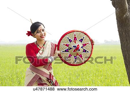 Portrait of Bihu woman holding a jaapi View Large Photo Image Stock Photo - Portrait of Bihu woman holding a jaapi . Fotosearch