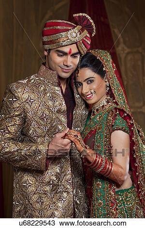 Portrait of bride resting her head on man's shoulder while holding hands View Large Photo Image Stock Image - Portrait of bride resting her head on man's shoulder while holding hands . Fotosearch