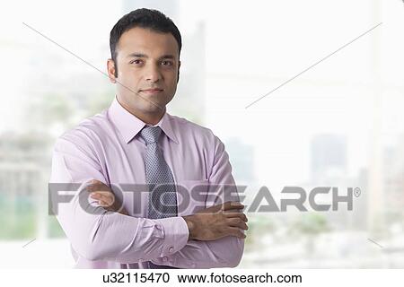 Portrait of business executive with arms folded View Large Photo Image Stock Image - Portrait of business executive with arms folded . Fotosearch