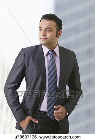 Stock Photograph - Portrait of businessman with hand in pocket . Fotosearch