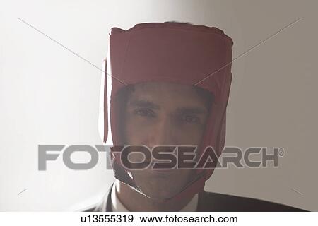 Stock Photo - Portrait of businessman with protective headgear . Fotosearch