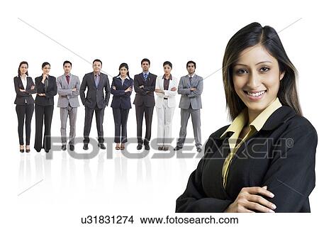 Picture - Portrait of businesswoman smiling with businesspeople in background . Fotosearch