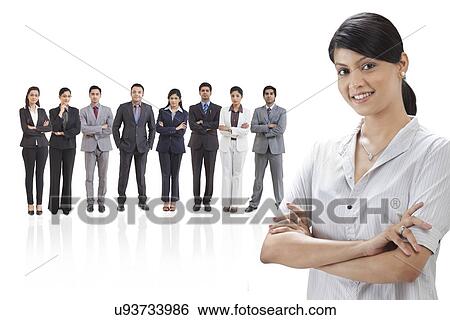 Portrait of businesswoman smiling with businesspeople in background View Large Photo Image Stock Photograph - Portrait of businesswoman smiling with businesspeople in background . Fotosearch