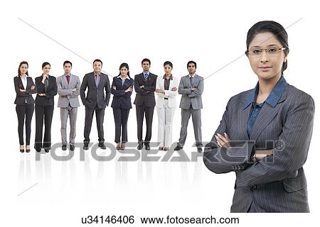 Stock Photograph - Portrait of businesswoman with businesspeople standing in background . Fotosearch