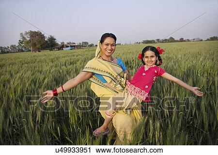 Portrait of carefree mother and daughter with arms out View Large Photo Image Stock Image - Portrait of carefree mother and daughter with arms out . Fotosearch