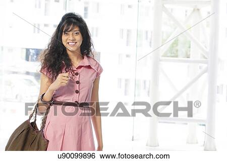 Portrait of cheerful young woman smiling View Large Photo Image Stock Photograph - Portrait of cheerful young woman smiling . Fotosearch