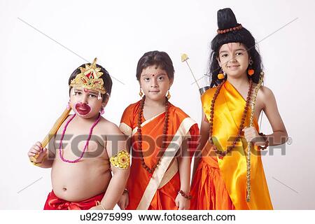 Stock Photo - Portrait of children dressed as Hanuman, Sita and Ram against white background. Fotosearch