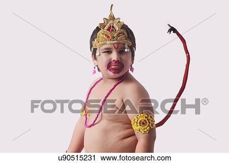 Portrait of confident boy dressed as God Hanuman against white background View Large Photo Image Stock Image - Portrait of confident boy dressed as God Hanuman against white background. Fotosearch