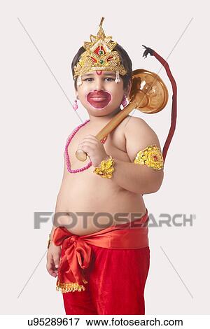 Portrait of confident boy dressed as God Hanuman against white background View Large Photo Image Stock Photo - Portrait of confident boy dressed as God Hanuman against white background. Fotosearch