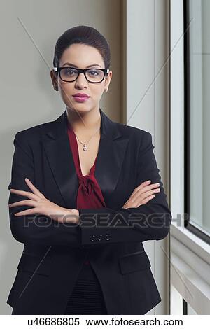 Portrait of confident businesswoman in office View Large Photo Image Stock Photography - Portrait of confident businesswoman in office. Fotosearch