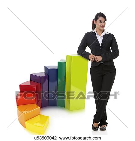 Stock Image - Portrait of confident businesswoman with multi colored bar graph representing growth over white background. Fotosearch