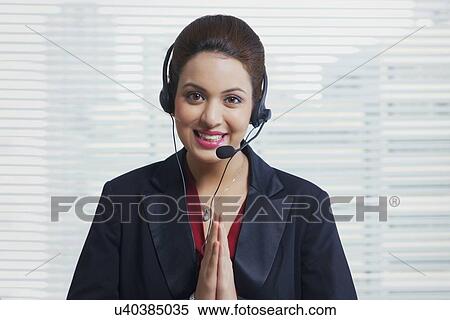 Portrait of confident customer service representative greeting in office View Large Photo Image Stock Photography - Portrait of confident customer service representative greeting in office. Fotosearch