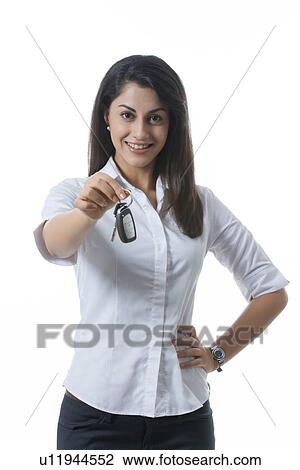Portrait of confident Indian businesswoman holding car keys against white background View Large Photo Image Stock Image - Portrait of confident Indian businesswoman holding car keys against white background. Fotosearch